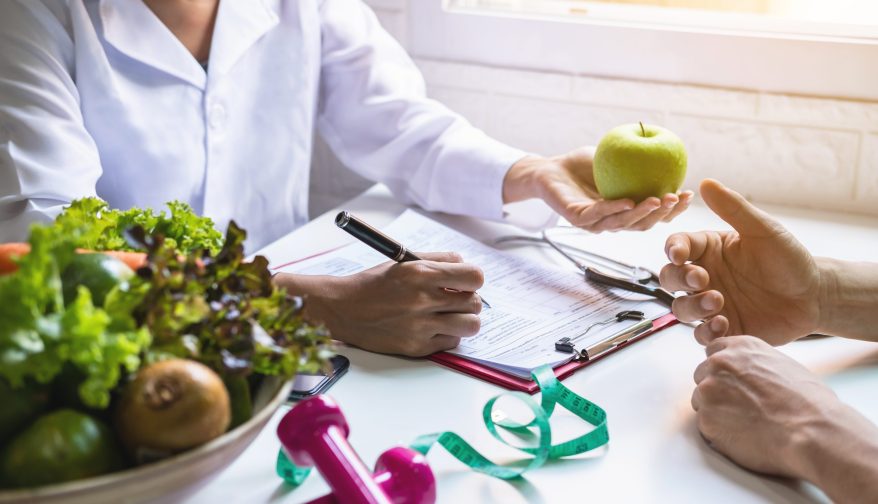 Nutritionist giving consultation to patient with healthy fruit and vegetable, Right nutrition and diet concept